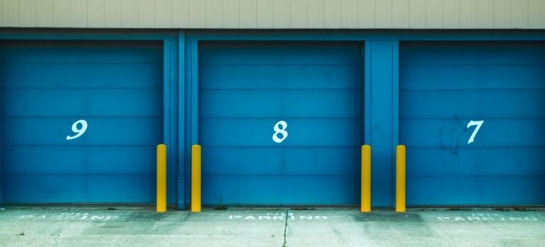 Storage units with blue doors and numbers on them