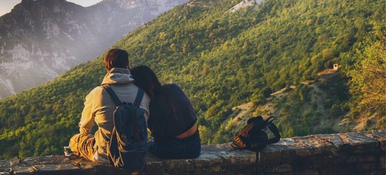 Couple sitting and looking at mountains