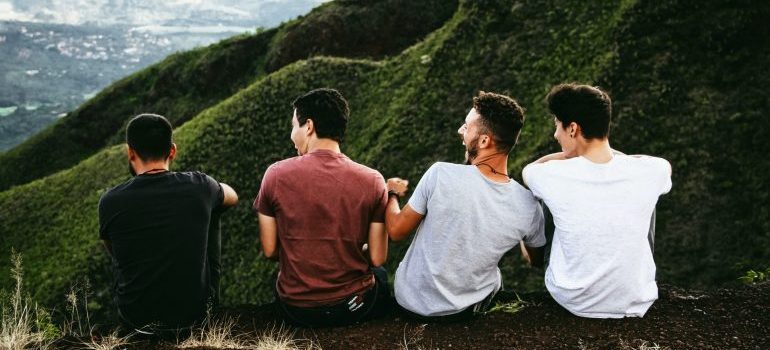 friends sitting on a cliff