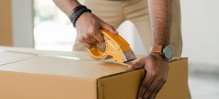 man packing a box for a long-distance move