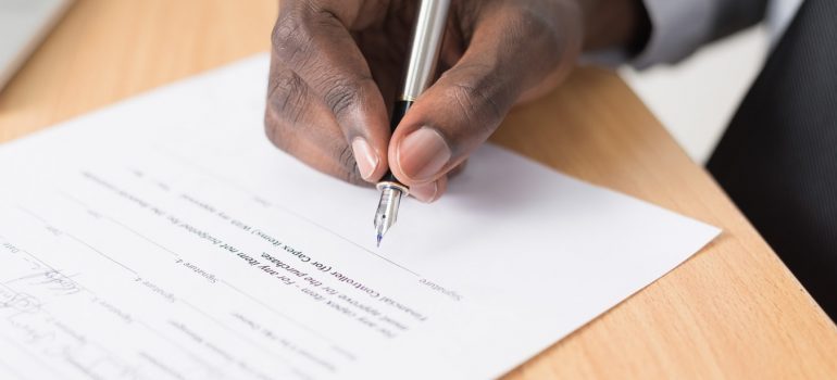 A man signing a contract