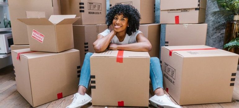 A girl surrounded by moving boxes