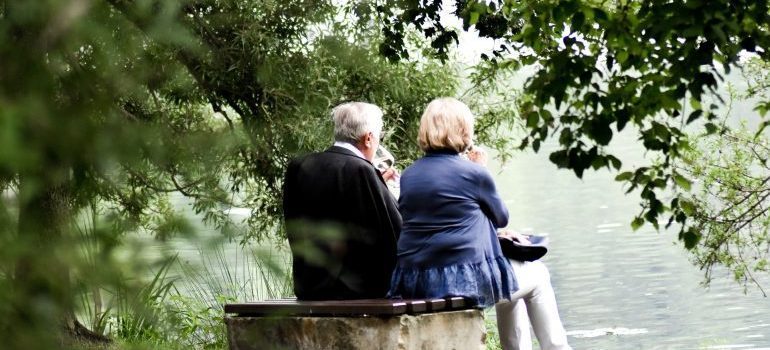 Elderly man and woman sitting on a bench