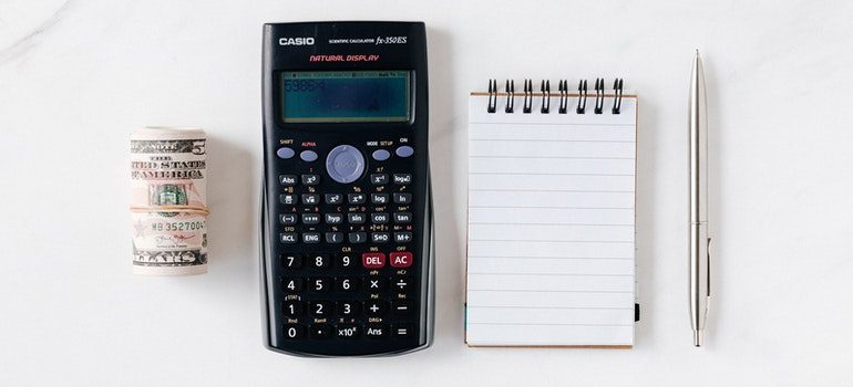 money, calculator, notepad, and a pen