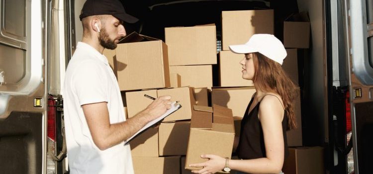 a woman and a man packing boxes